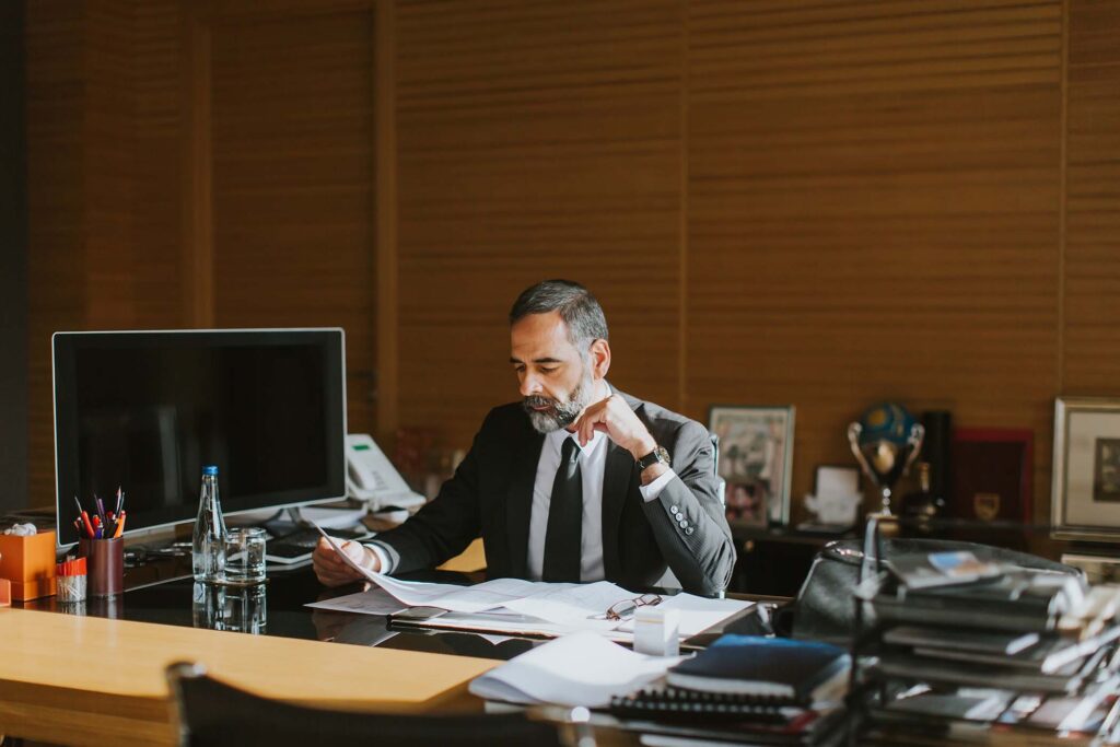 senior-businessman-working-on-laptop-in-modern-off-6YLNRXL.jpg